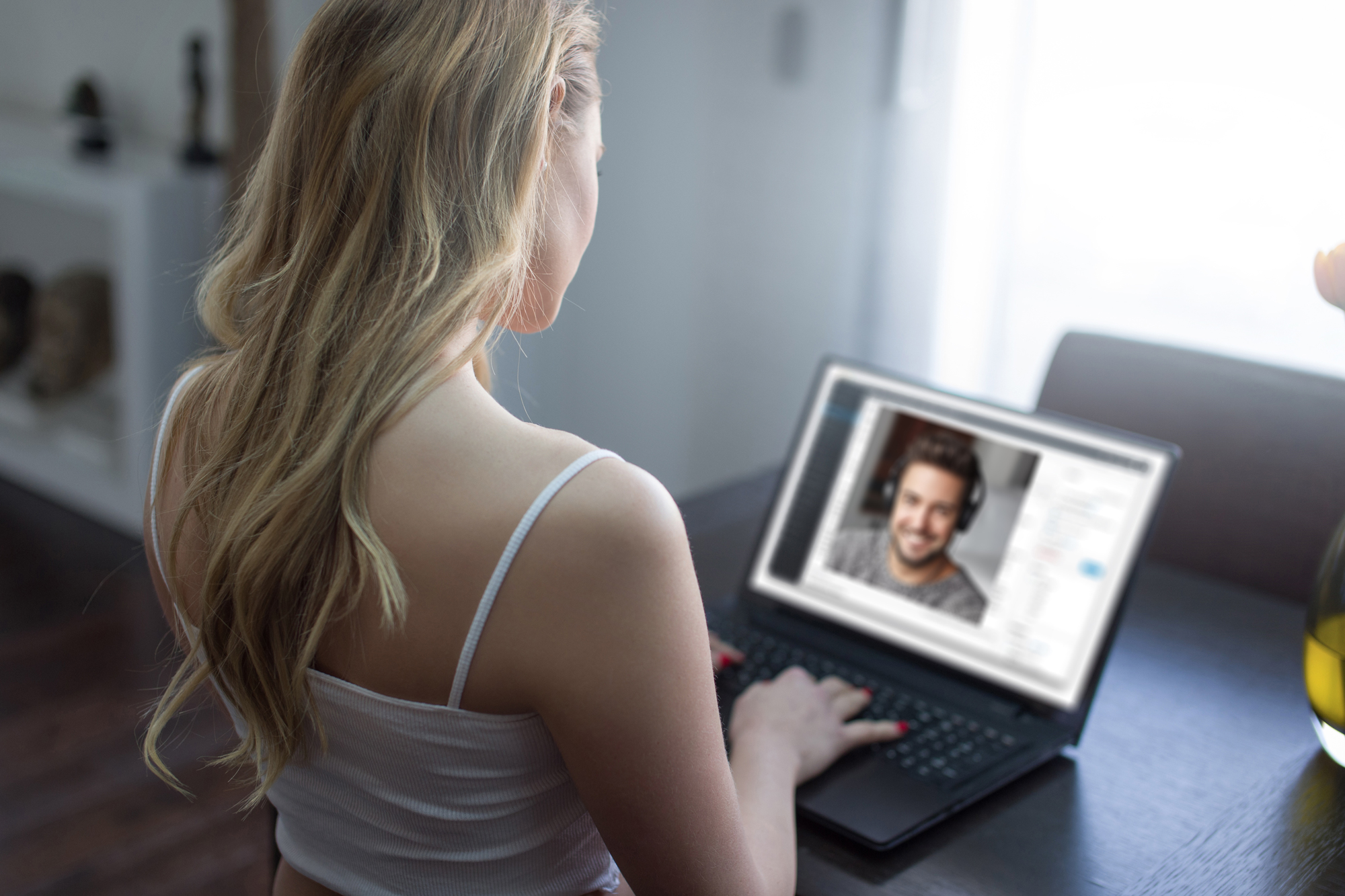 Woman on video date with man in living room